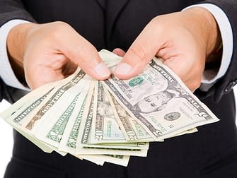 a man holding a dollar bill upfront