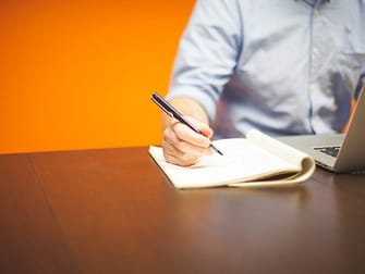 a man working with computer and notes