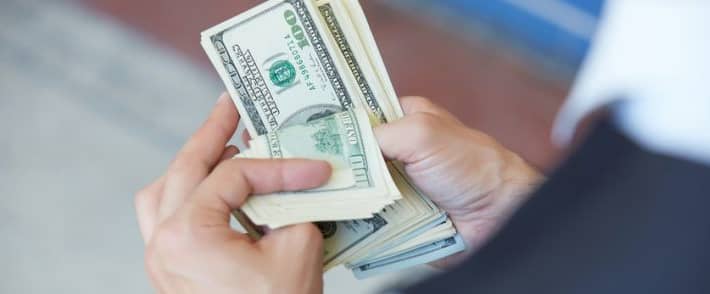 a person holding a dollar money
