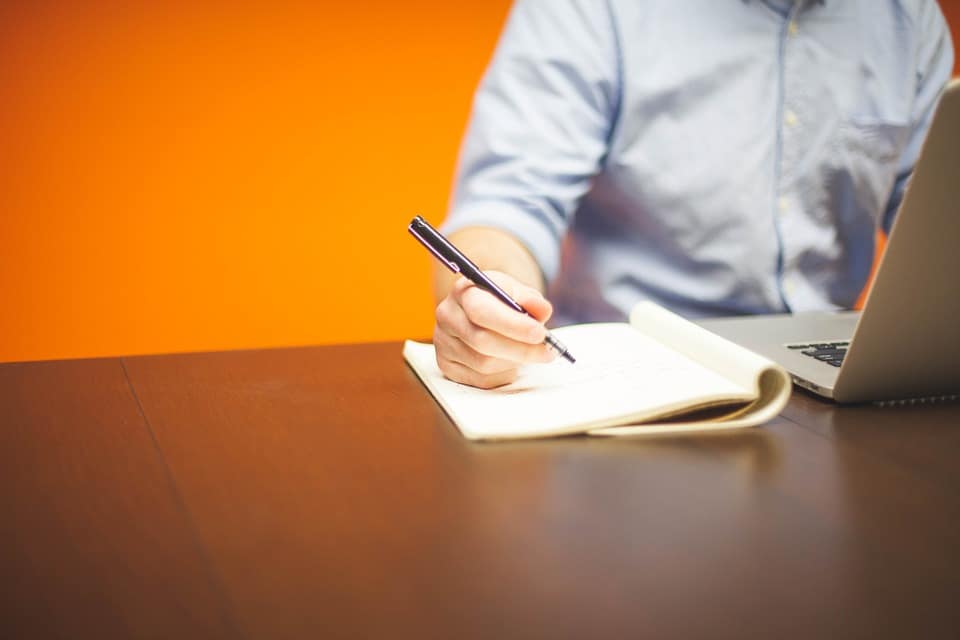 a man working with computer and notes