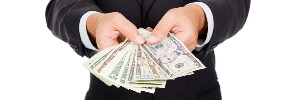 a man holding a dollar bill upfront